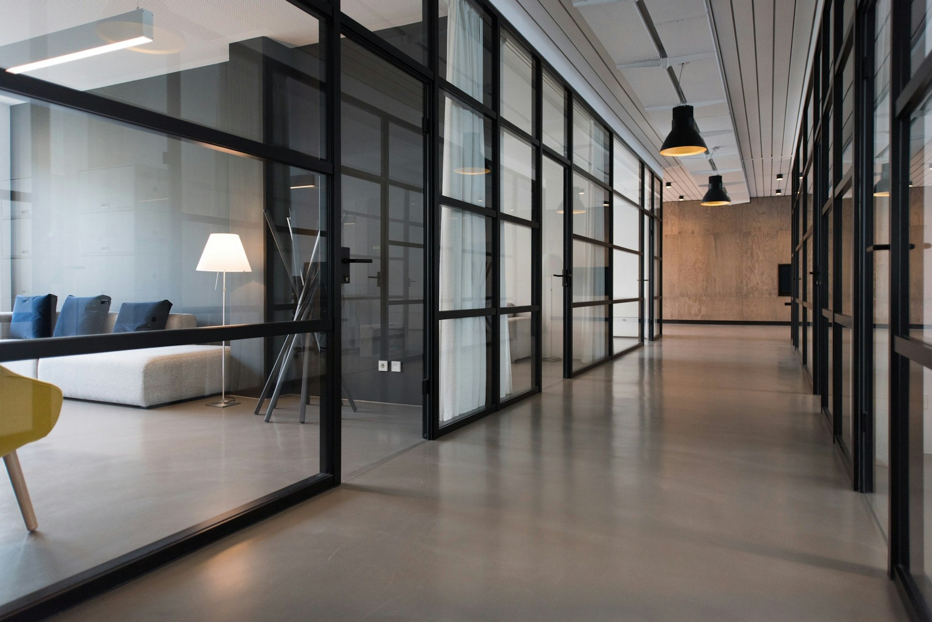 Late afternoon light falling through tall windows into a calm, empty room